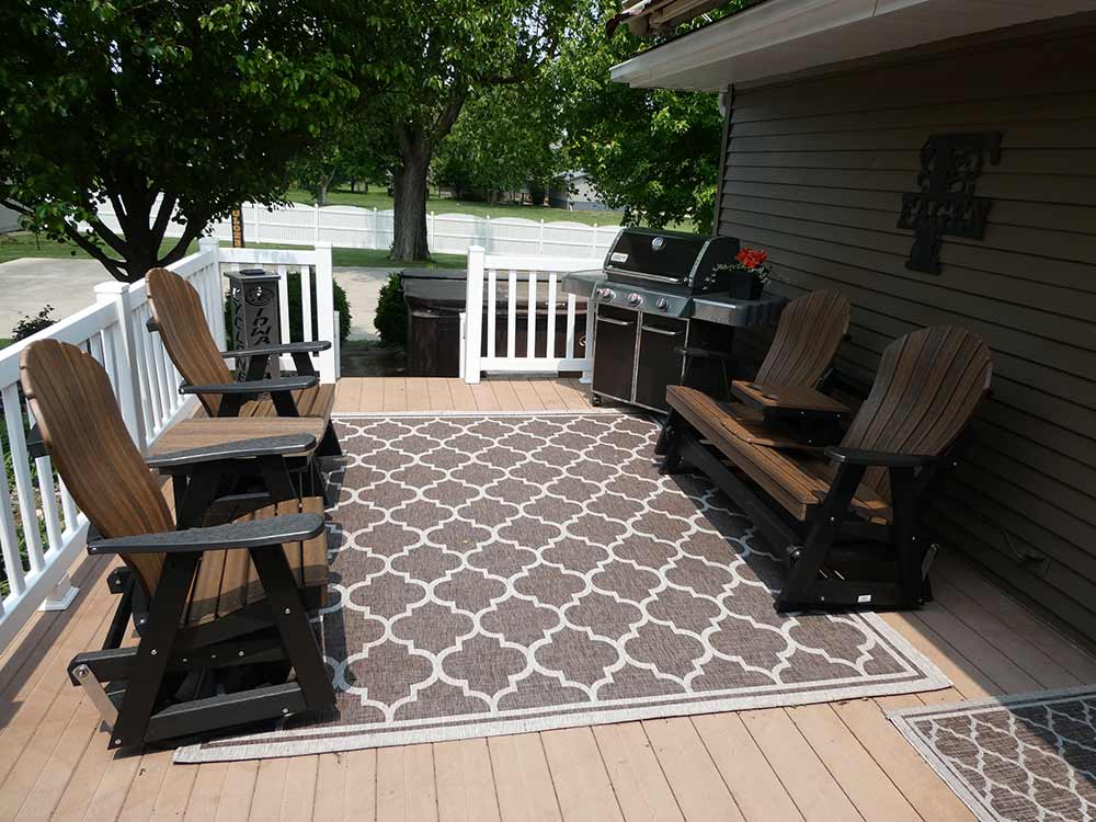 Back porch with poly furniture and grill.